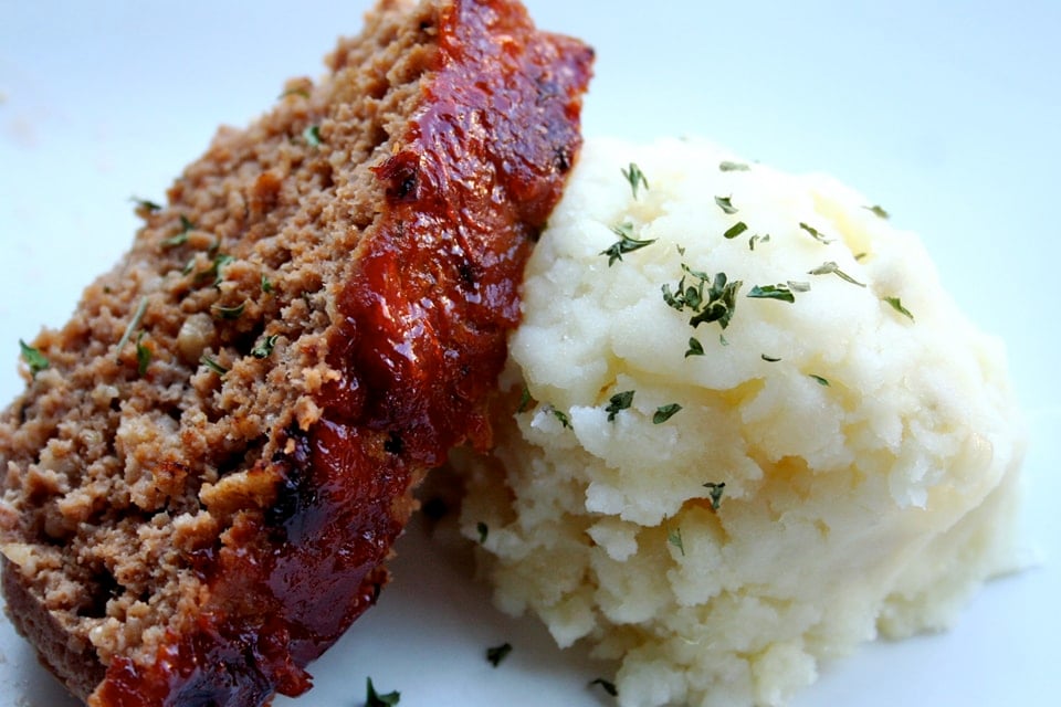 meatloaf leaning on a mound of mashed potatoes