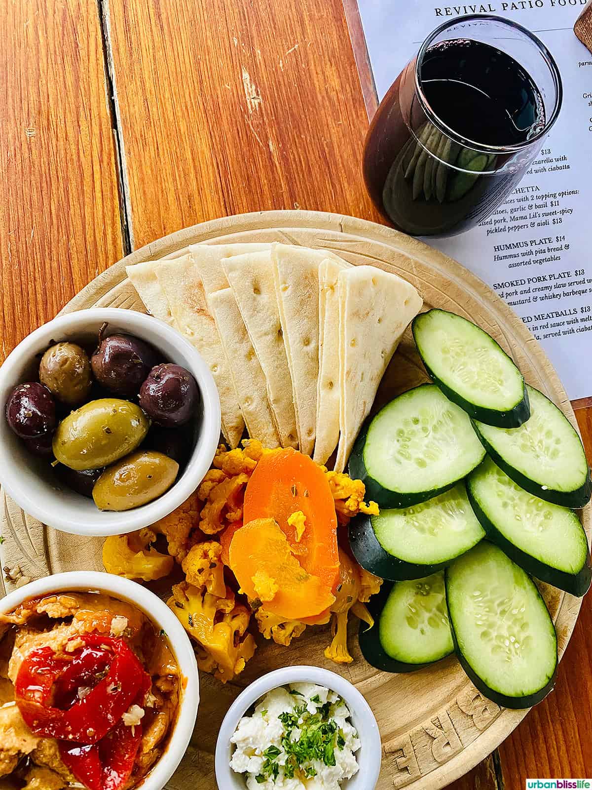 snack plate and glass of red wine at Bible Club PDX.