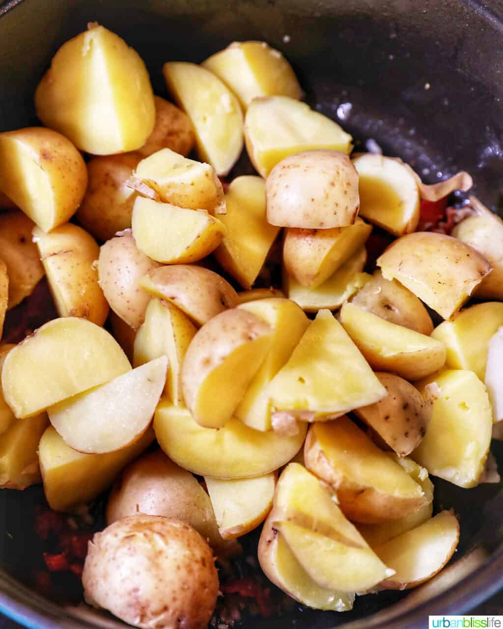 adding cut potatoes to the pot