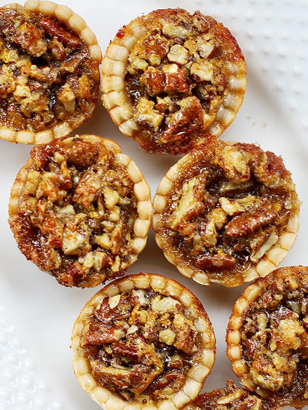 mini pecan pies on a serving platter.