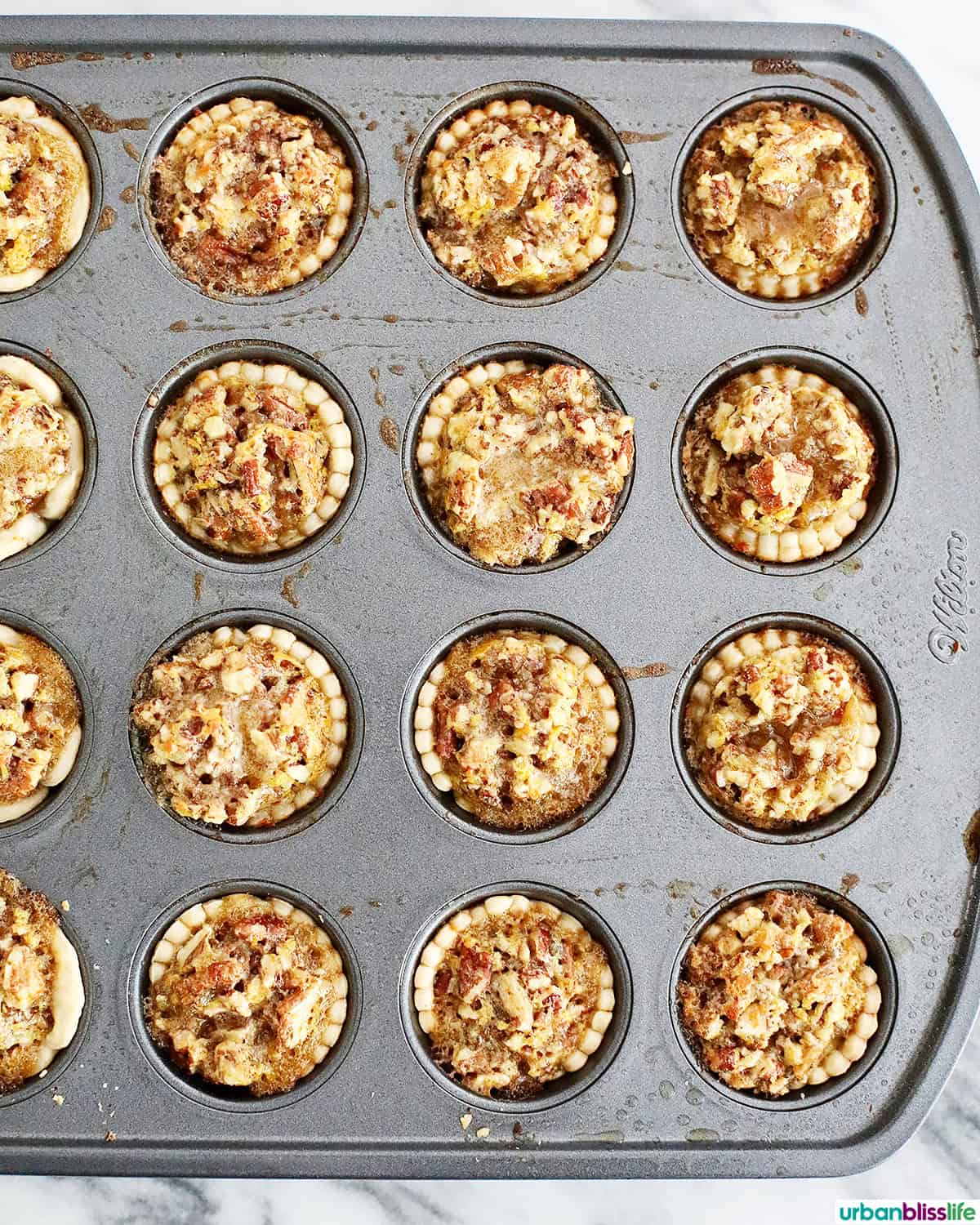 mini pecan pies in a baking pan.