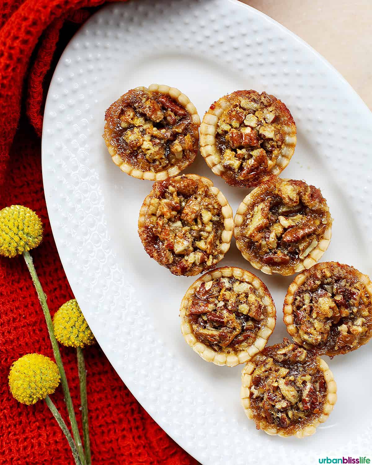 mini pecan pies on a serving platter.