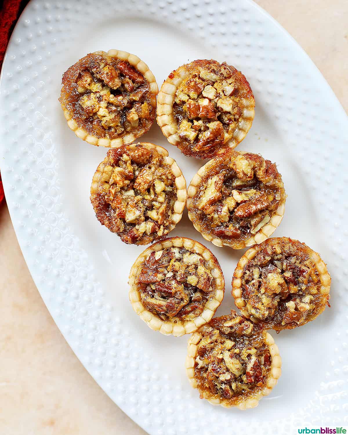 mini pecan pies on a serving platter.