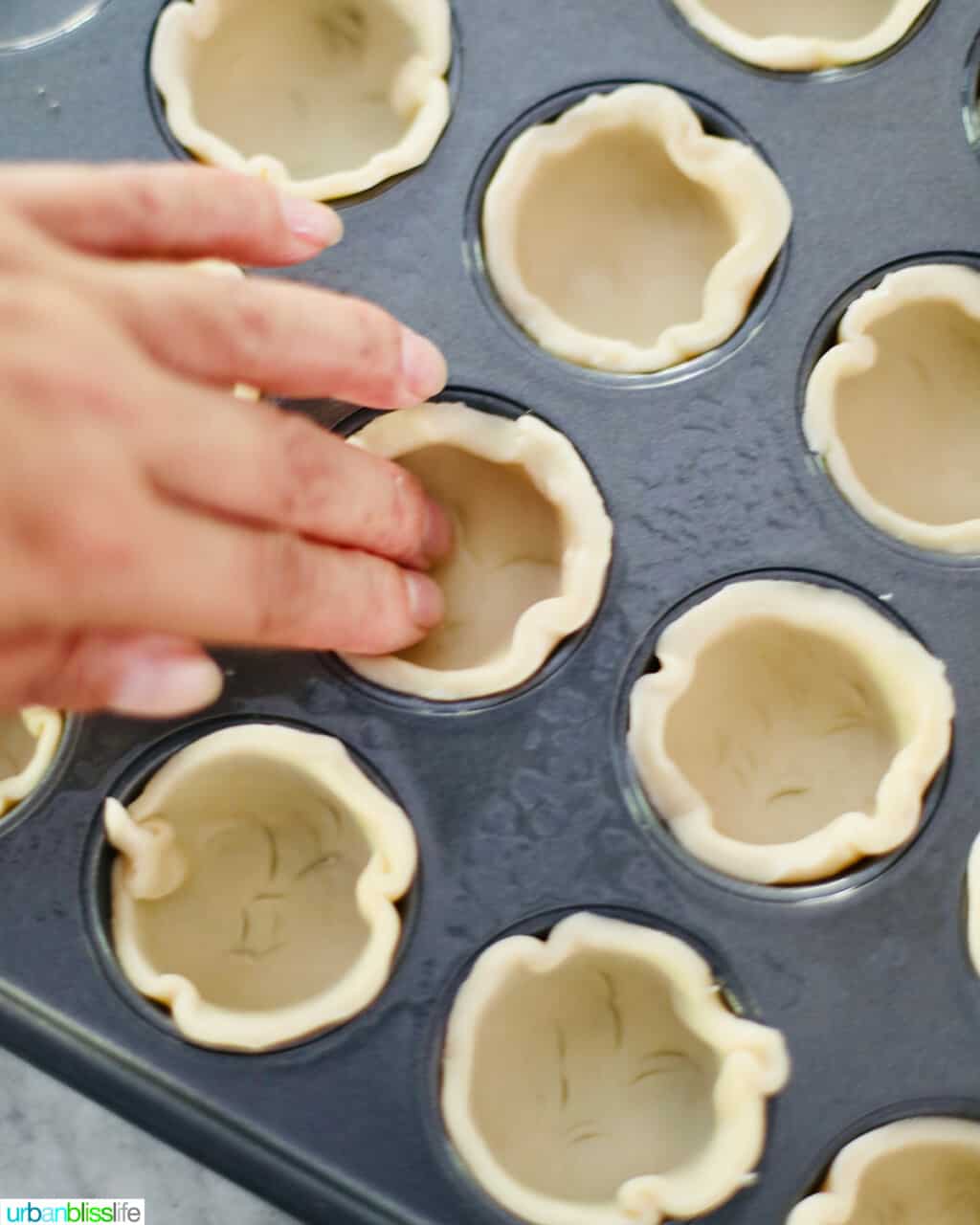pushing dough into mini muffin pan