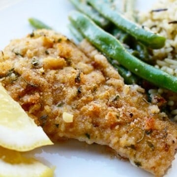 pan-fried cod with lemon & white wine with lemon slices, and rice.