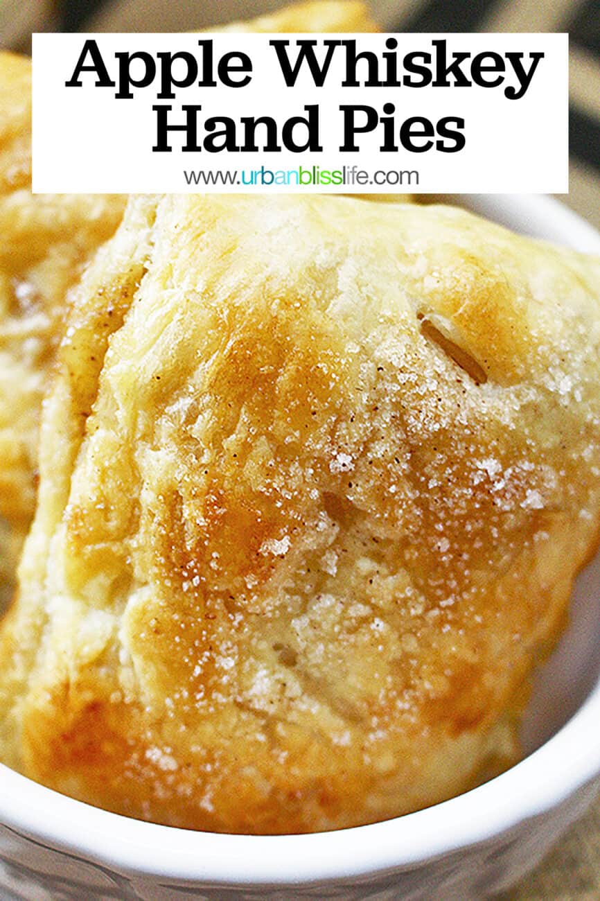 two apple whiskey hand pies in a white bowl with title text overlay.