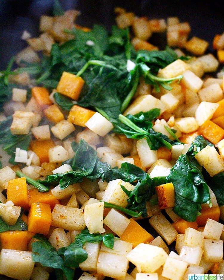 butternut squash hash cooking with spinach
