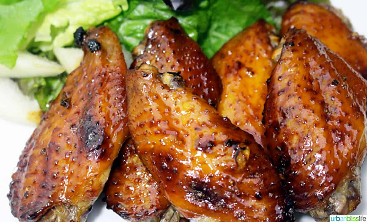 honey bourbon chicken wings stacked on top of each other.
