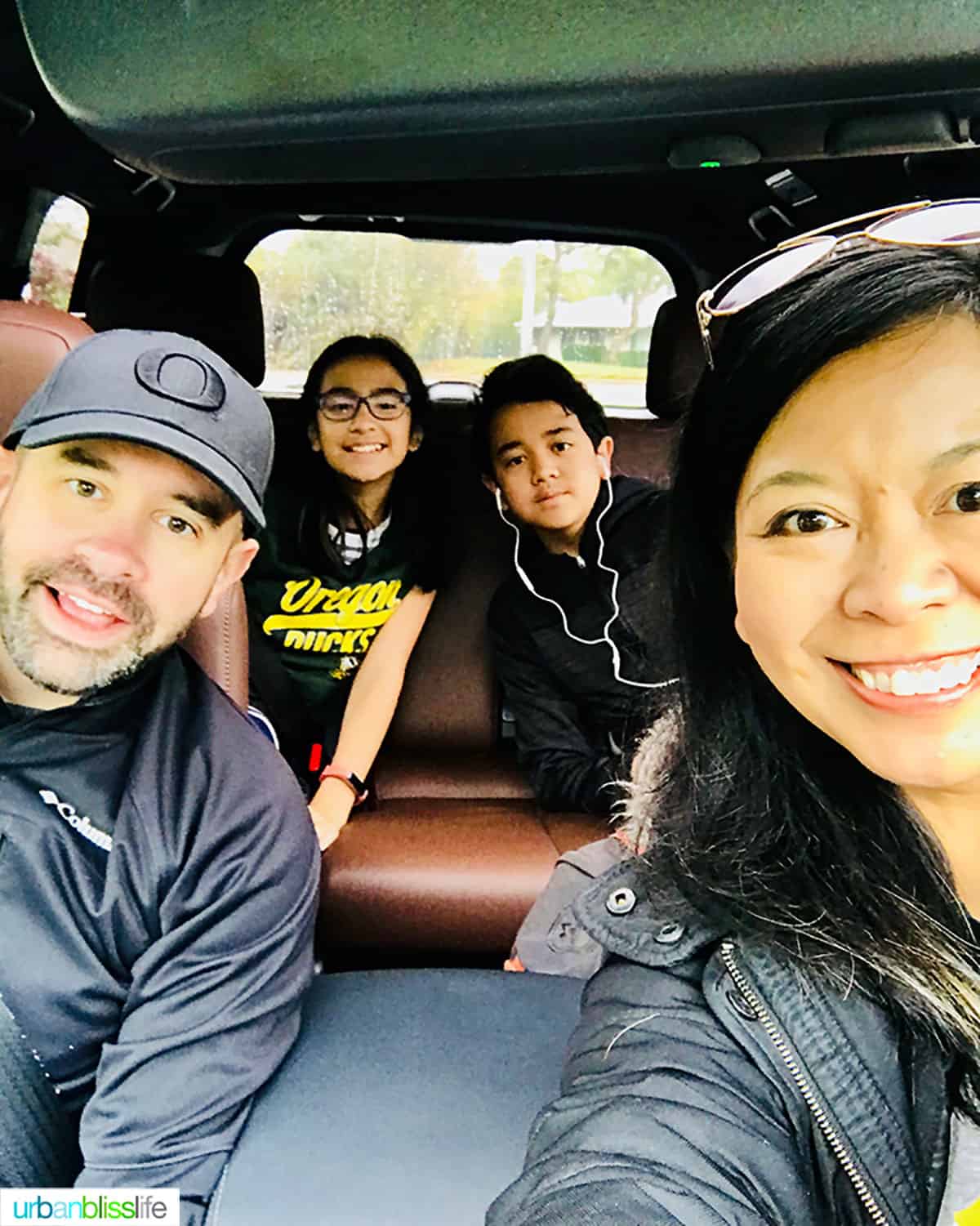 family of four in a car for a road trip.