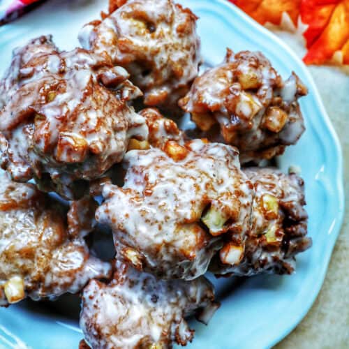 apple fritter donuts stacked on top of each other on a plate.