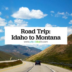 car on a highway with rolling hills and mountains with title text that reads "Road Trip: Idaho to Montana."