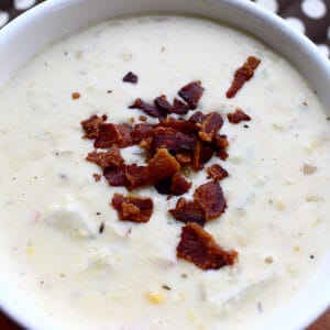 bowl of bacon corn seafood chowder with bacon crumbles on top.