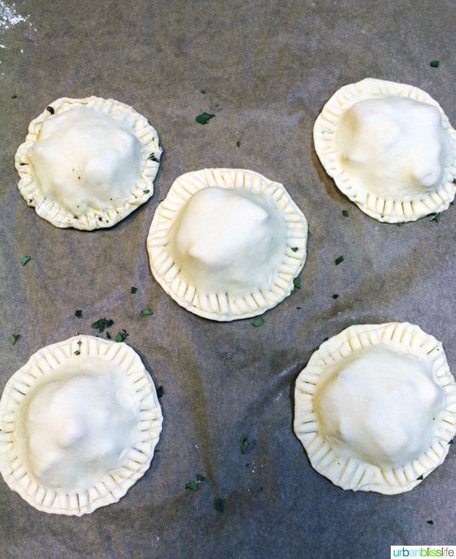 unbaked puff pastry hand pies on parchment paper.