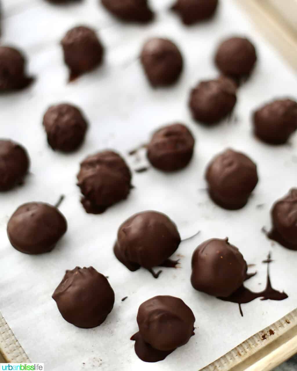 chocolate coated Oreo truffles on a baking sheet