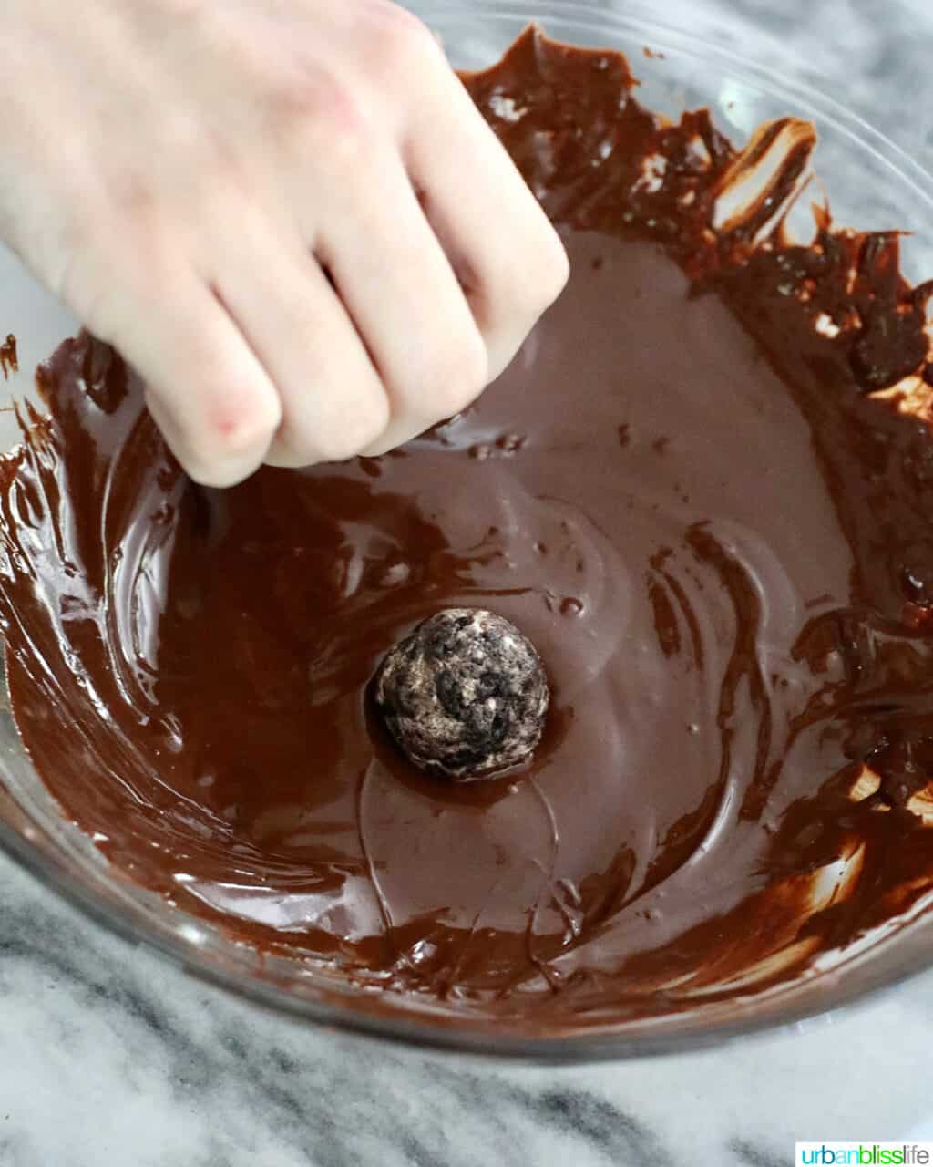coating Oreo truffles with melted chocolate