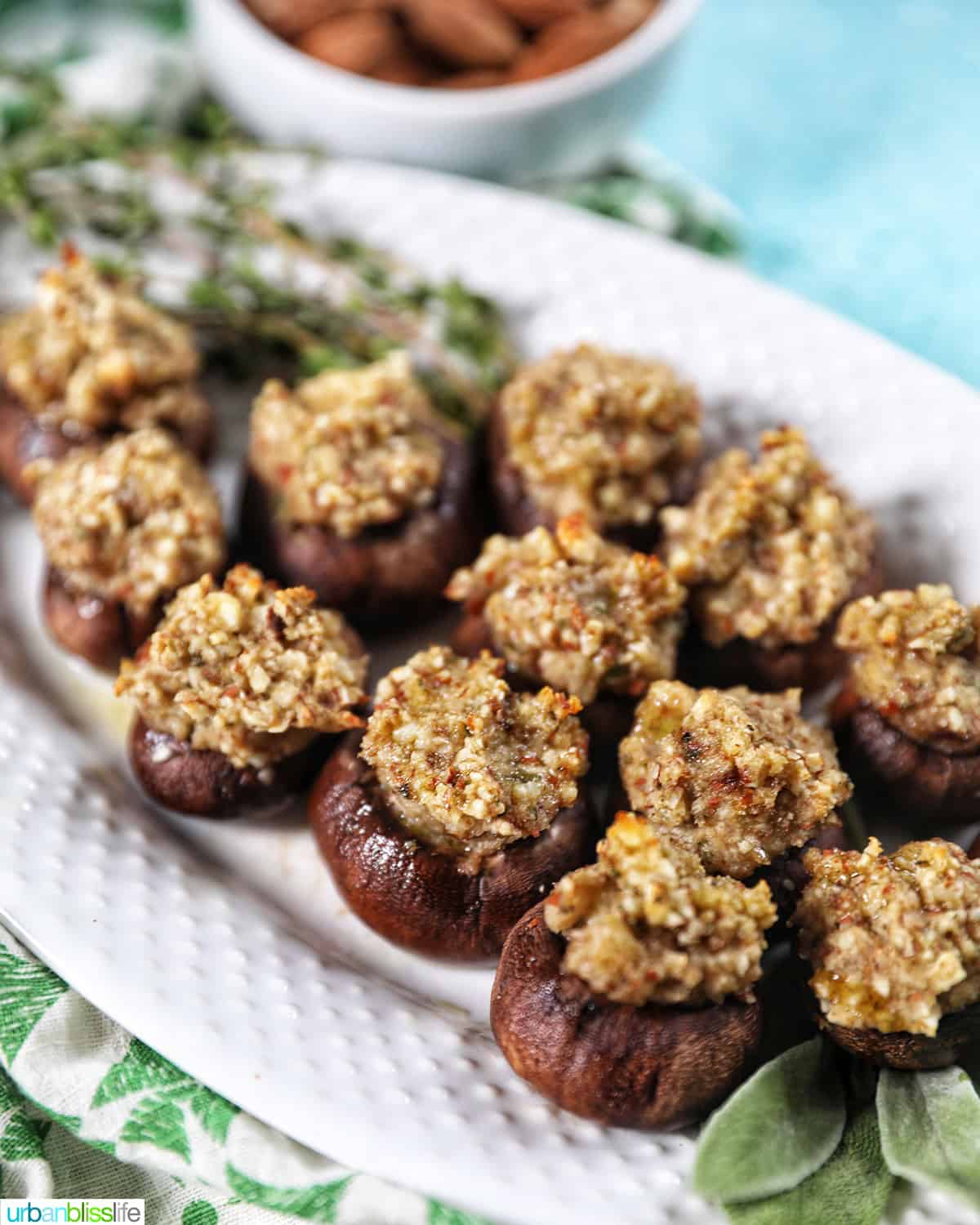 several vegan stuffed mushrooms on a white plate.