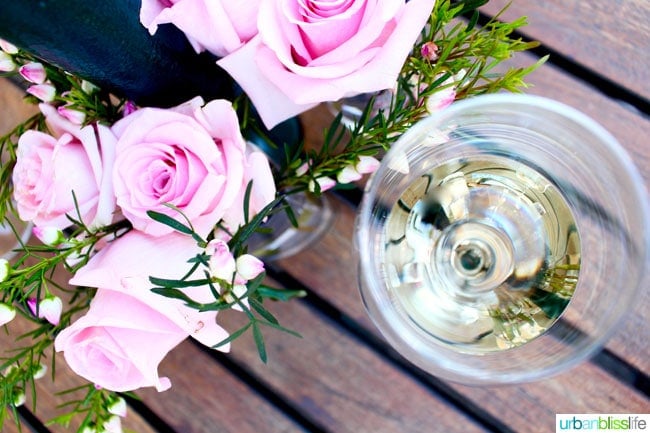 glass of Riesling wine with pink roses