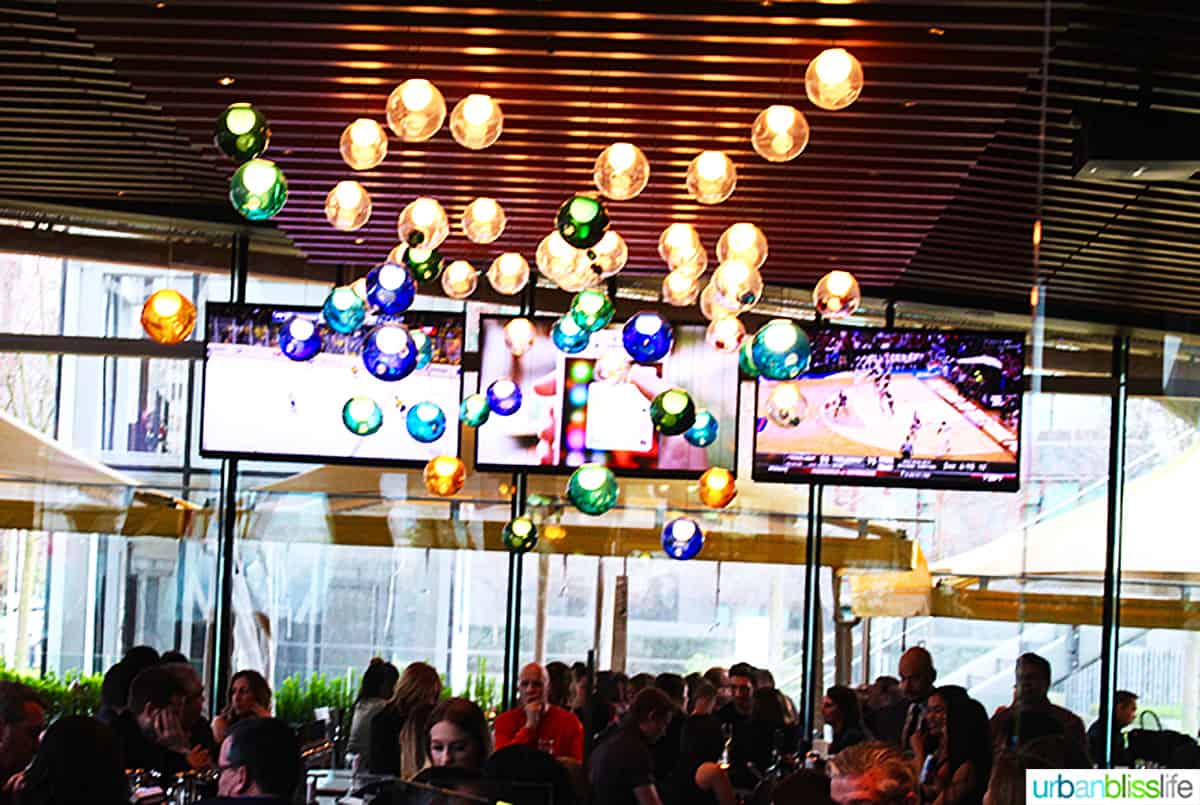colorful round light fixture in the ceiling at Cactus Club Cafe Coal Harbour Vancouver BC.