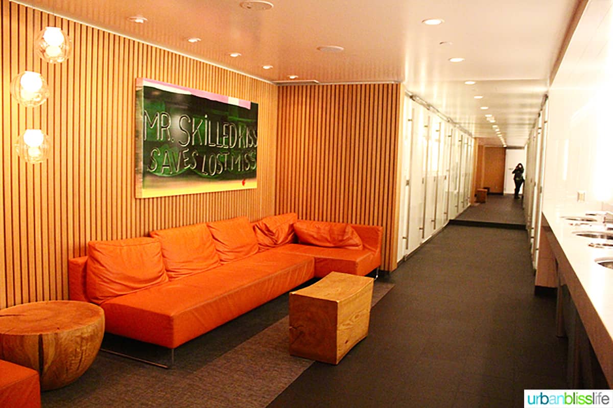 hallway with orange couch and decorative wall art at Cactus Club Cafe coal harbour.