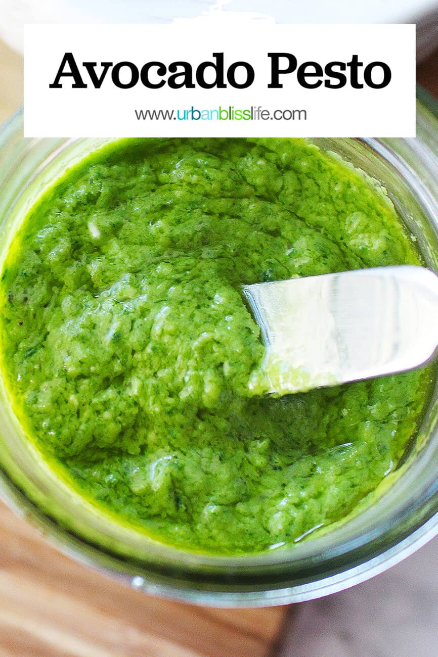 bright green avocado pesto in a mason jar with a small knife placed in the pesto with title text overlay.
