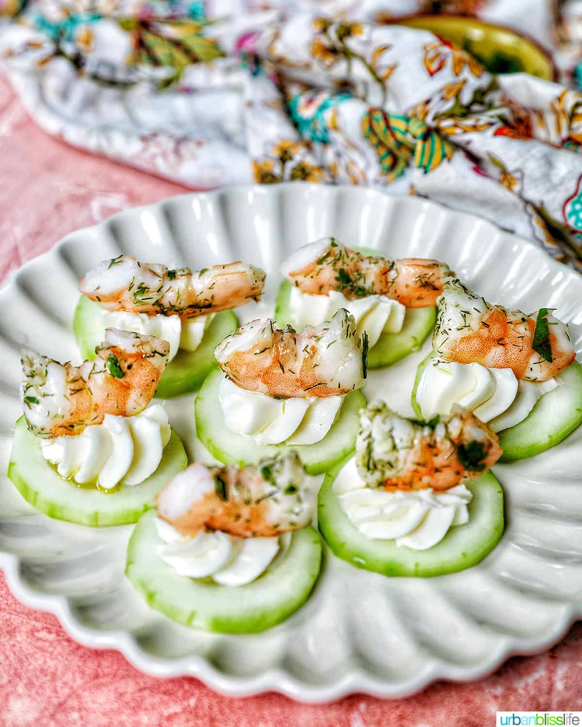 shrimp canapes on a scalloped plate.
