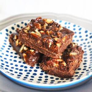 three salted caramel chocolate bars on a blue and white polka dot plate.