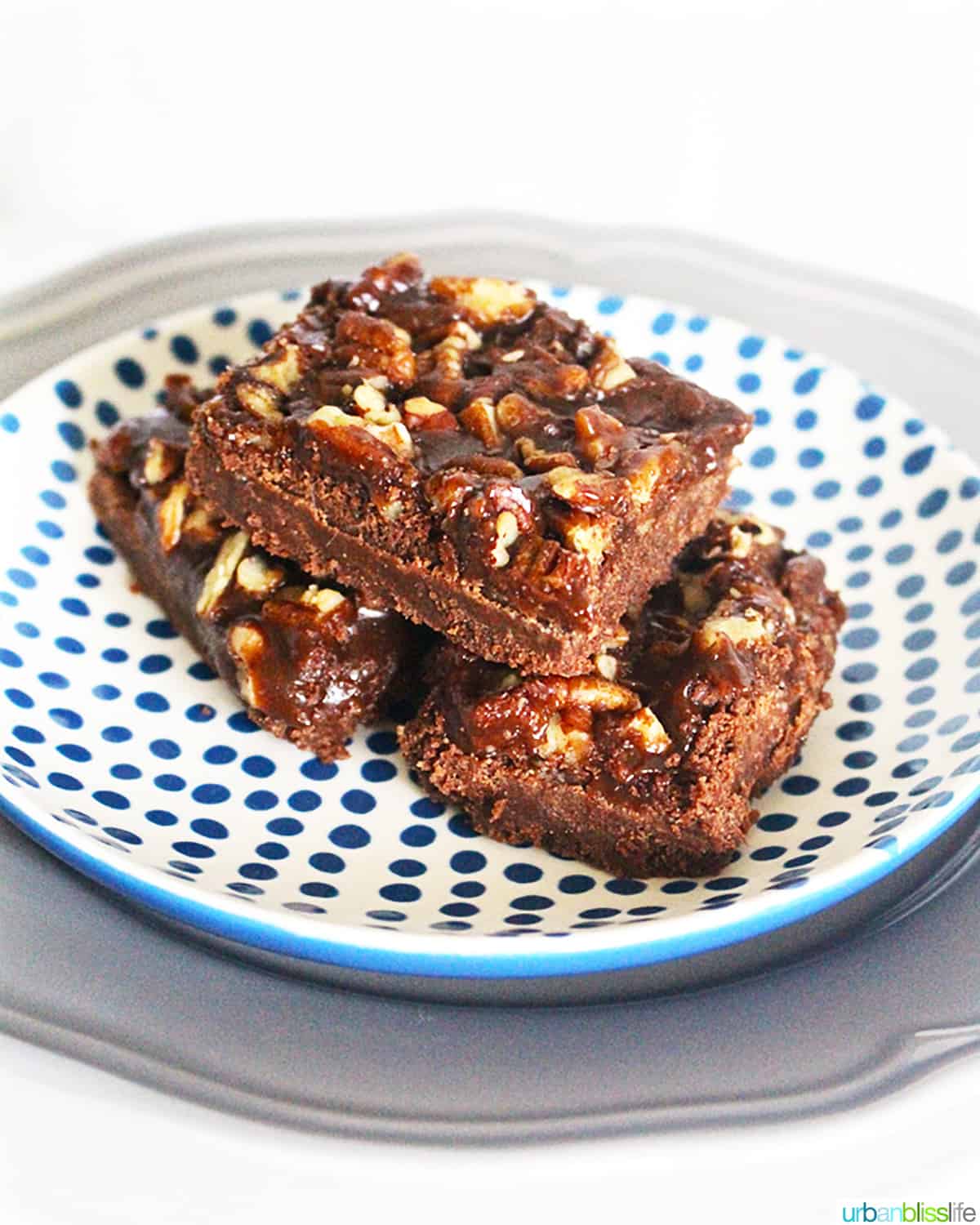 three salted caramel chocolate bars on a blue and white polka dot plate.