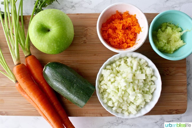 chopped apples, carrots, and zucchini in bowls