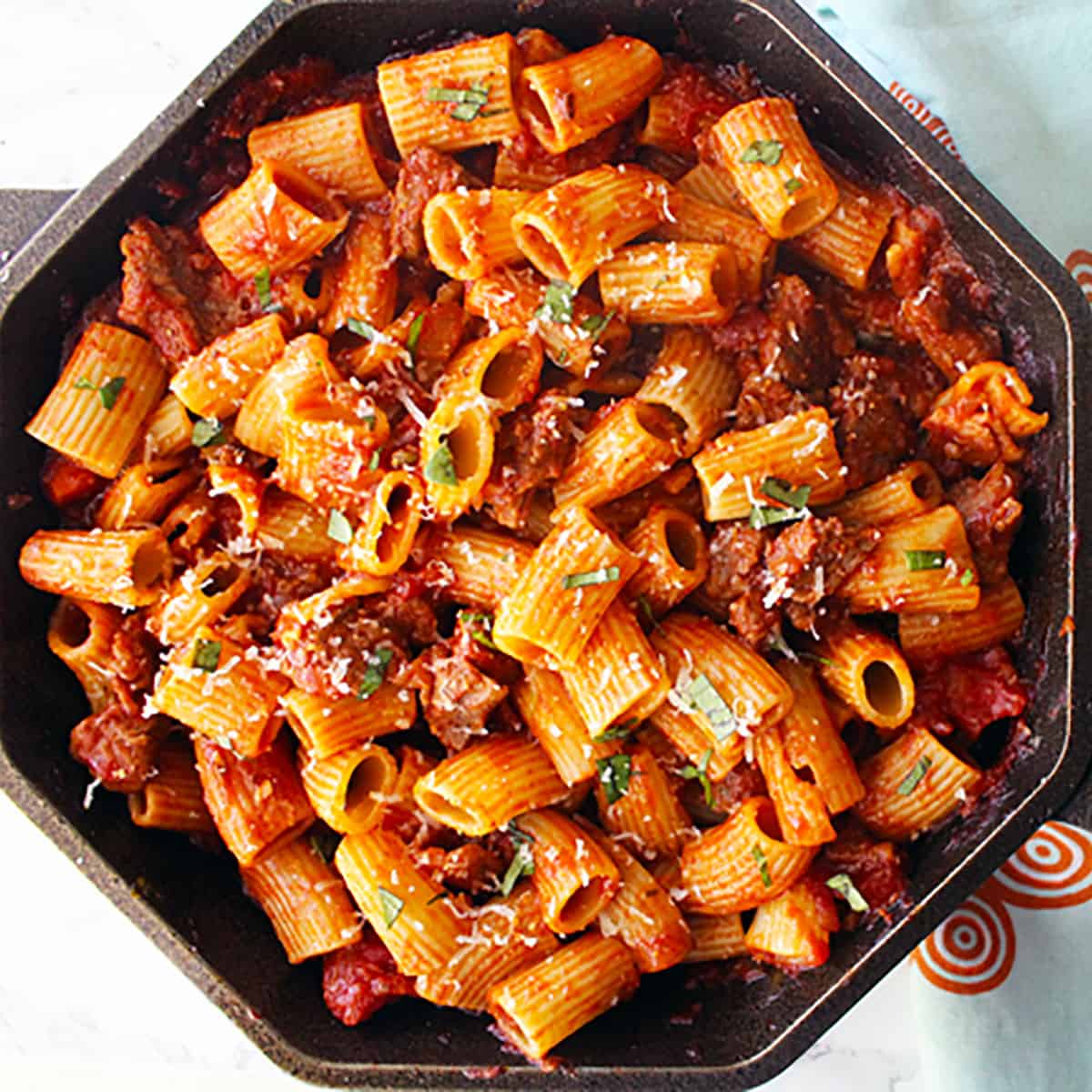 cast iron skillet with rigatoni with Italian sausage.