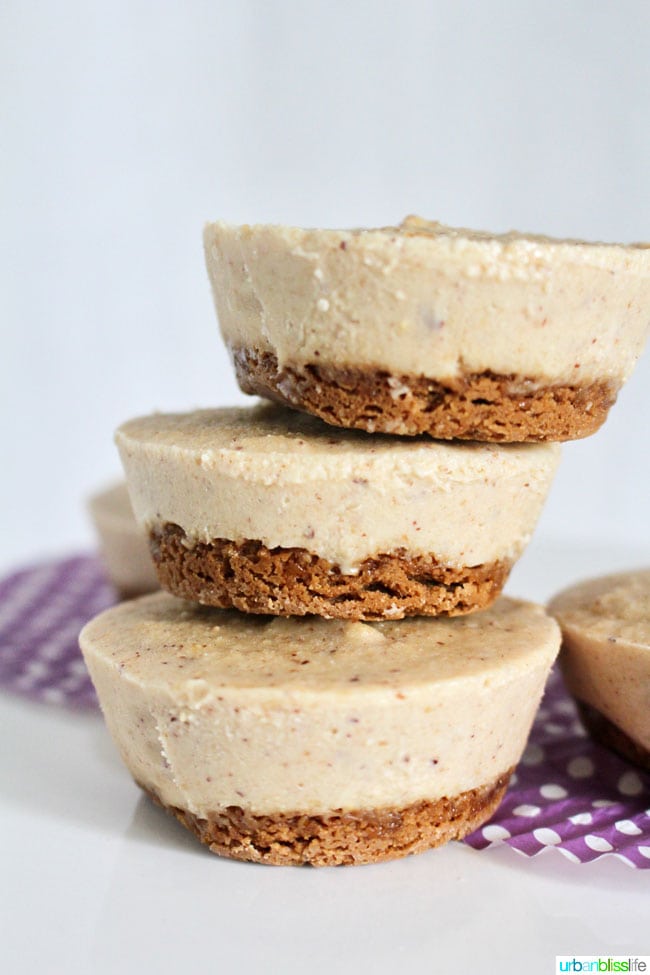 stack of three nutty vegan no bake cheesecake bites on a plate with purple polka dot wrapper.