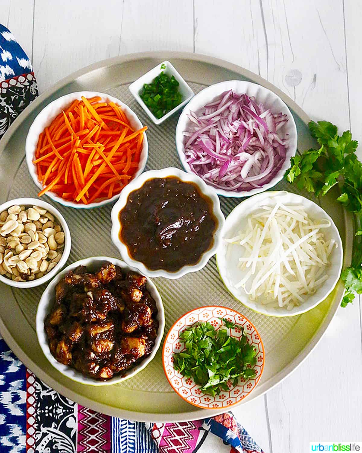 bowls of ingredients to make CPK Thai Chicken Pizza.