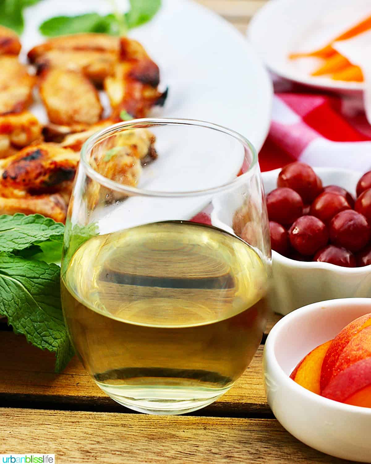 glass of white wine with BBQ sides.