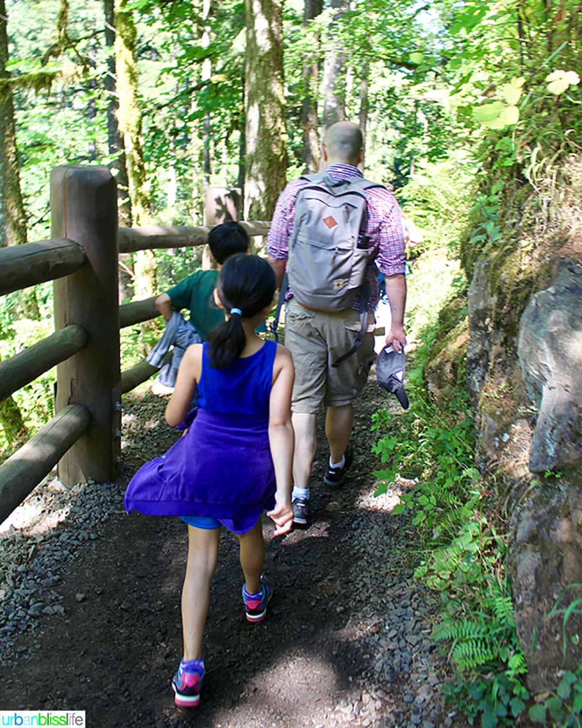 family hiking at Silver falls state park in oregon.