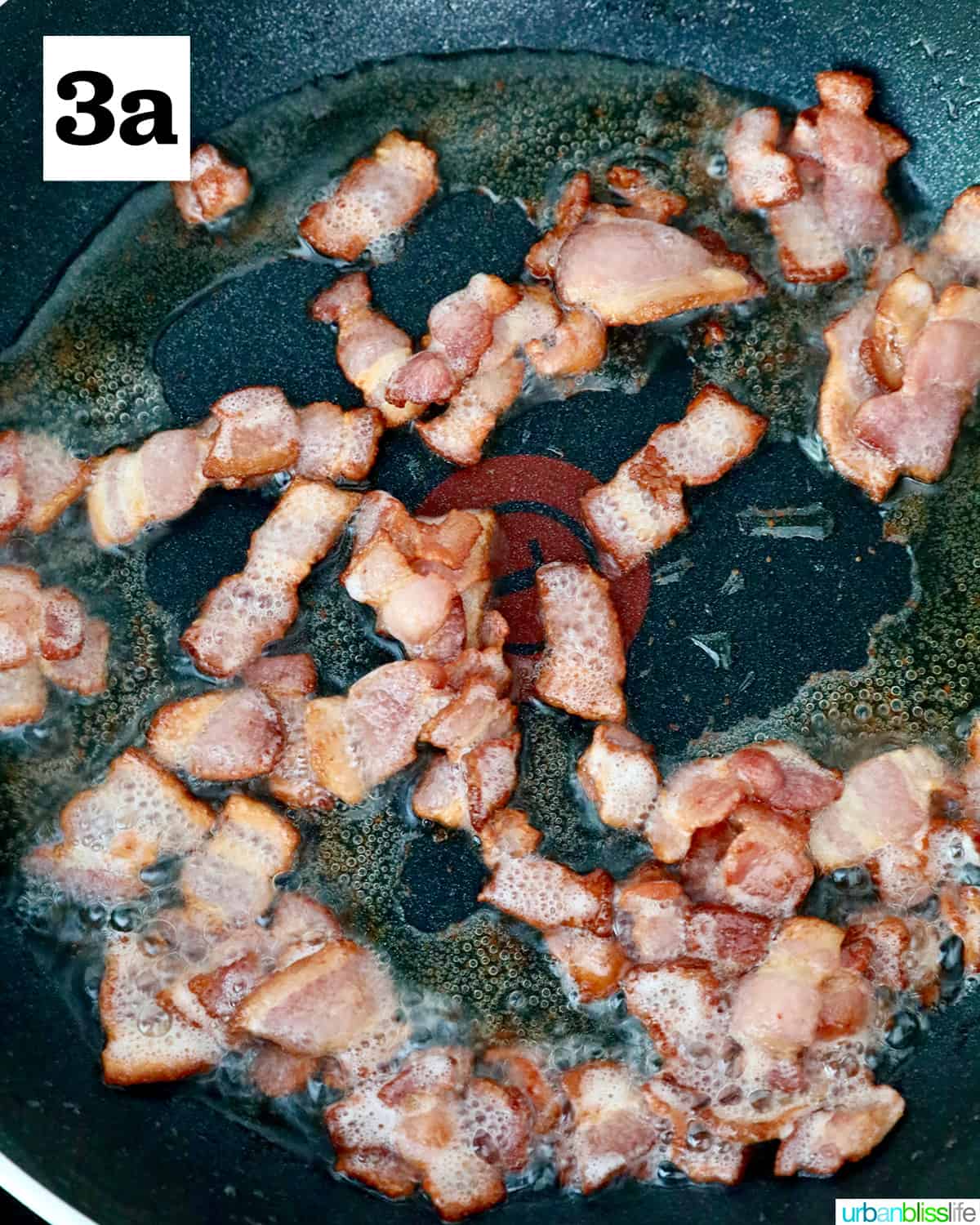 sliced bacon frying in a nonstick skillet.
