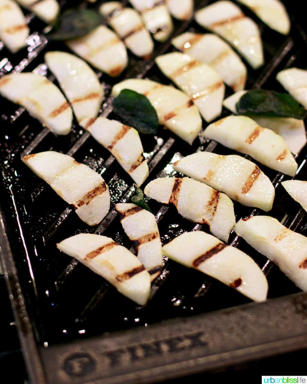 sliced apples with grill marks on a grill pan.