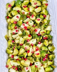 serving platter with roasted brussels sprouts, apples, pomegranate