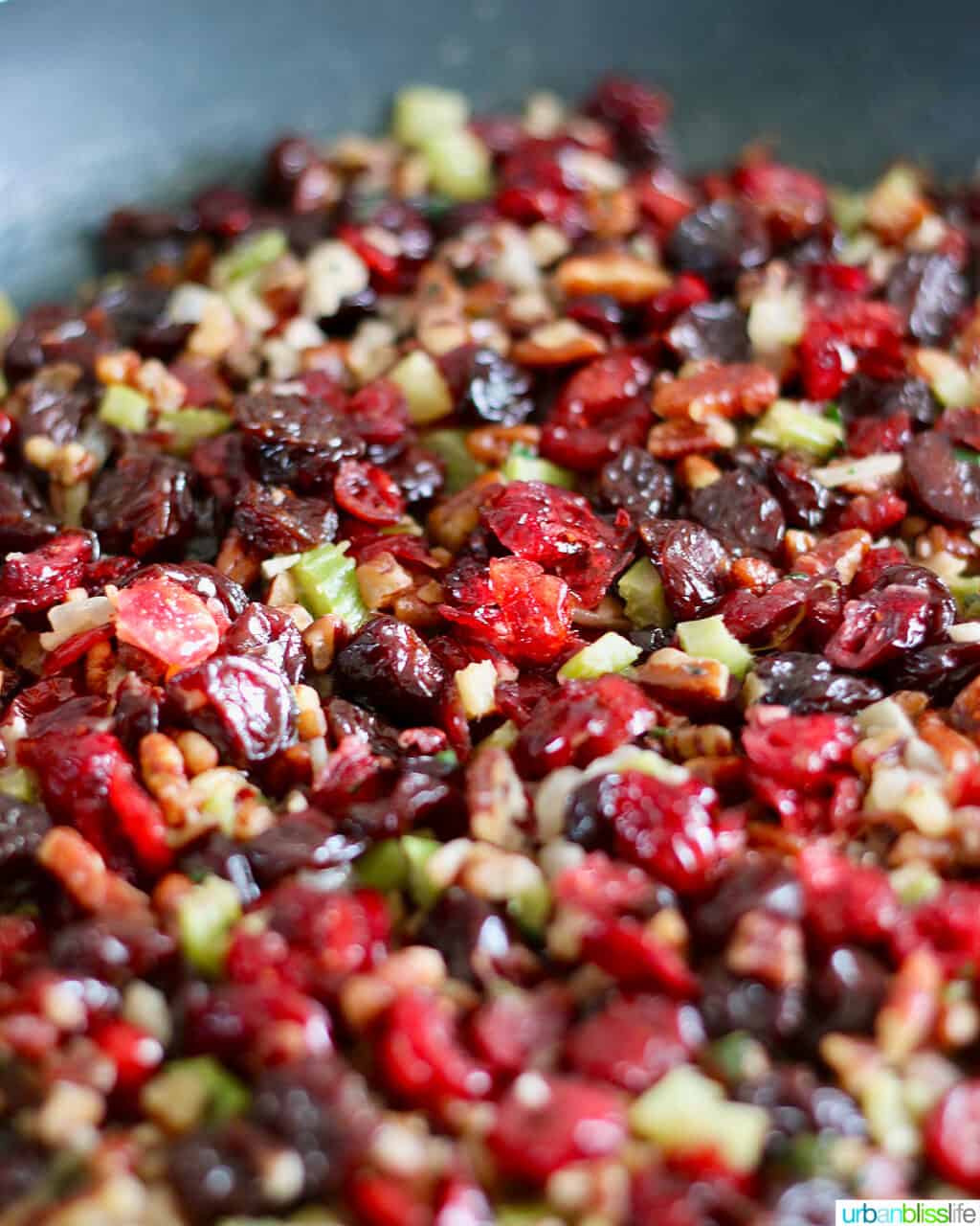 cranberry stuffing with wild rice, cherries, and pecans toasting in a skillet.