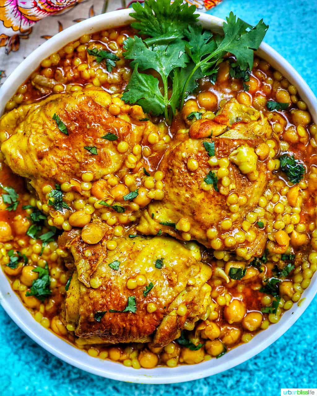 Instant Pot Moroccan Chicken in a large serving bowl with blue background