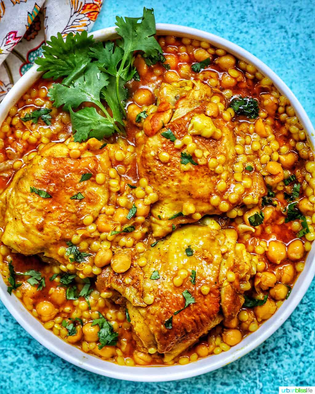 Instant Pot Moroccan Chicken in a large serving bowl with blue background