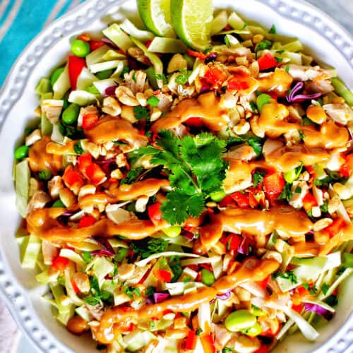 big bowl of Thai chicken salad with lime slices