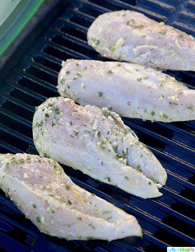 Lemon pepper chicken cooking on grill.