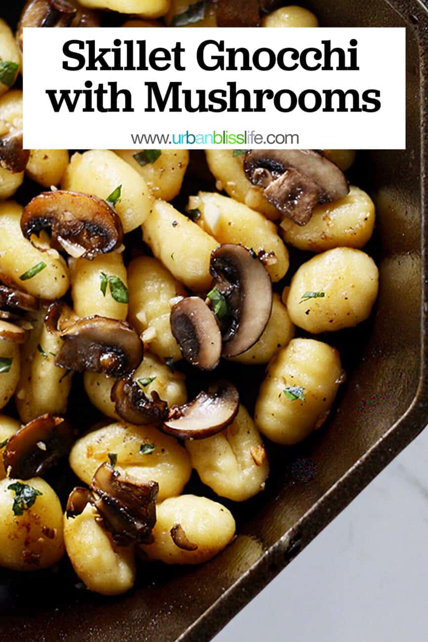 cast iron skillet with gnocchi, mushrooms, basil and title text.