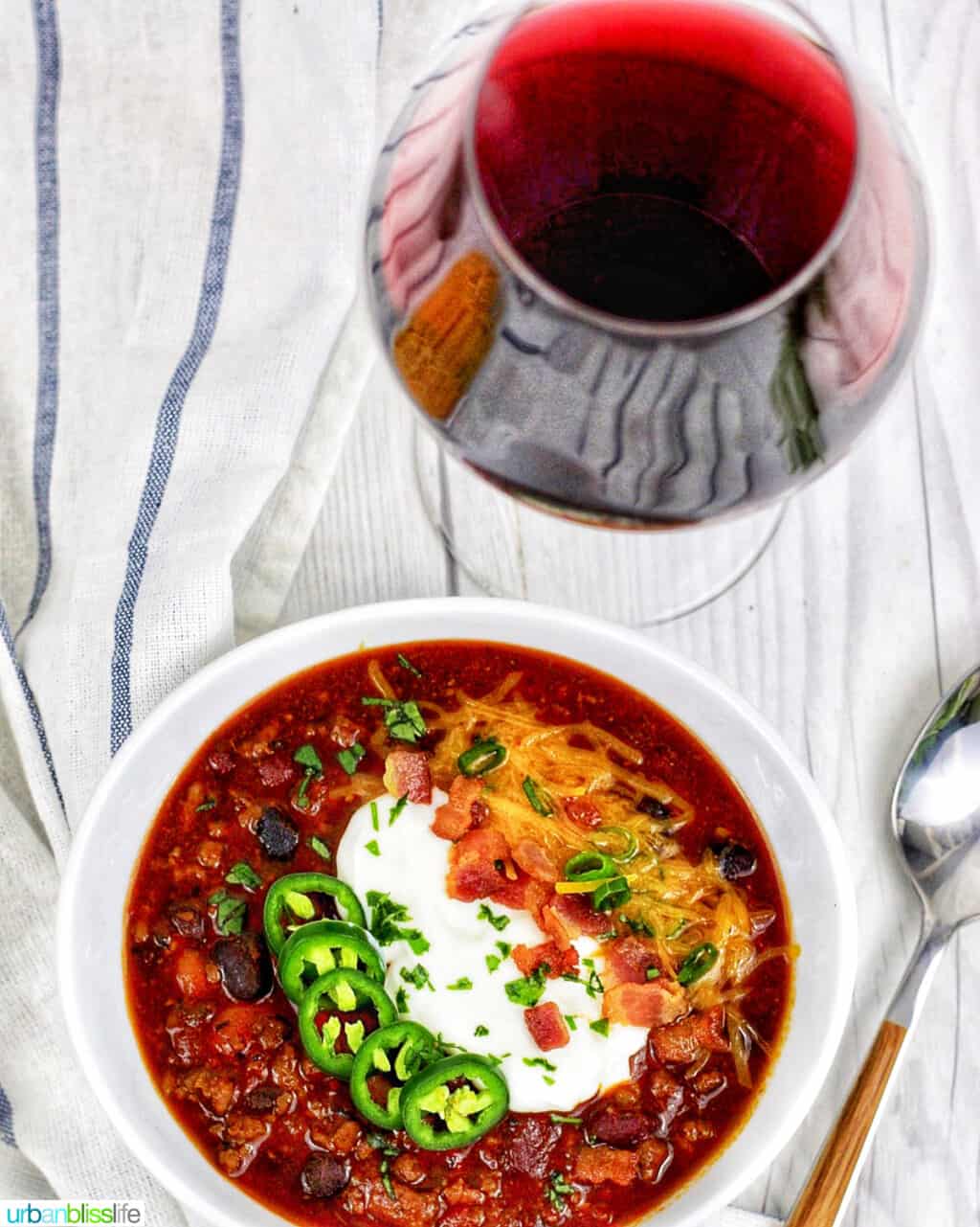 bowl of chili with glass of red wine