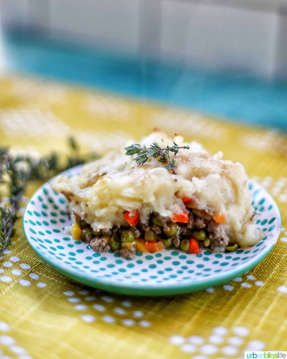 slice of shepherd's pie on a polka dot plate.