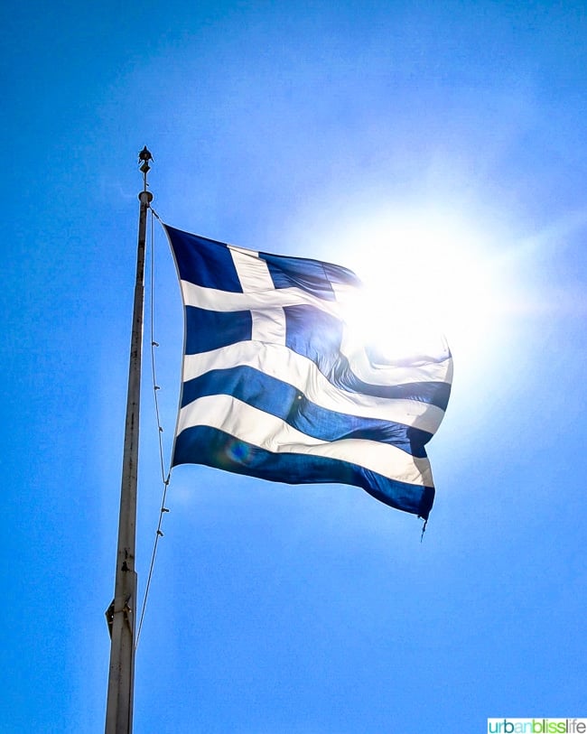 Greek flag with sun shining behind it ©UrbanBlissLife.com all rights reserved