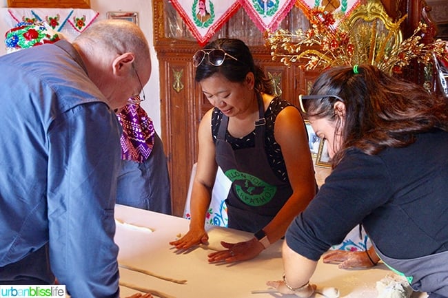 Marlynn and media group rolling dough and making makarounes pasta in Olympos Karpathos Greece.