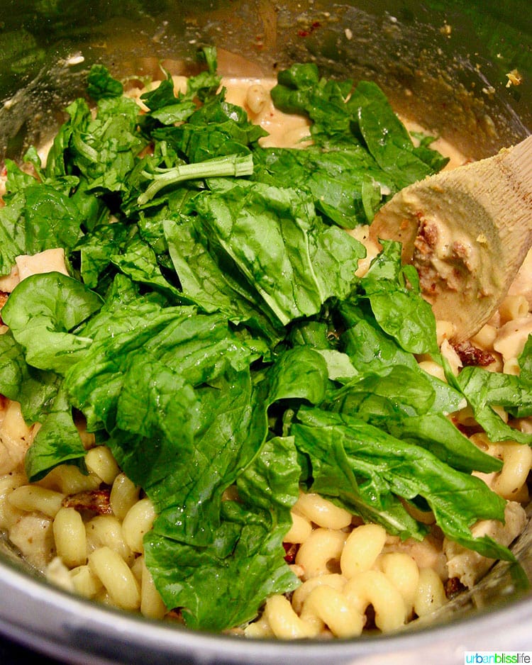 adding spinach to Dairy-Free Instant Pot Tuscan Chicken Pasta