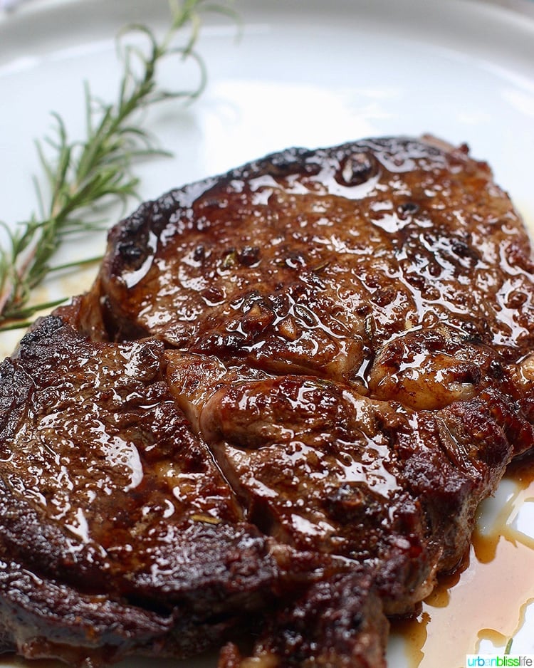 Cast iron rib eye steak done on plate resting.