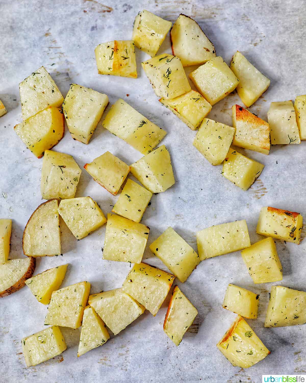 potatoes cubed on a sheet pan.