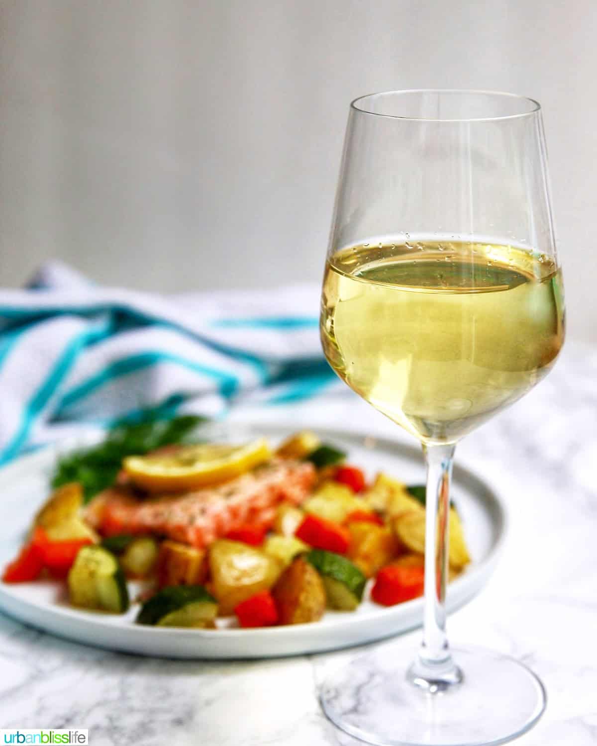 sheet pan salmon and vegetables with a glass of white wine.